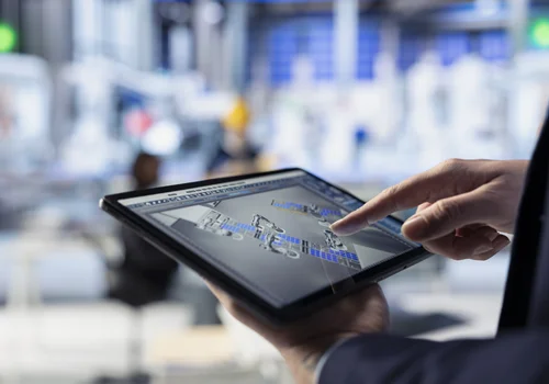 AV system design and engineering interface Engineer reviewing AV system design and network architecture using a tablet control interface.