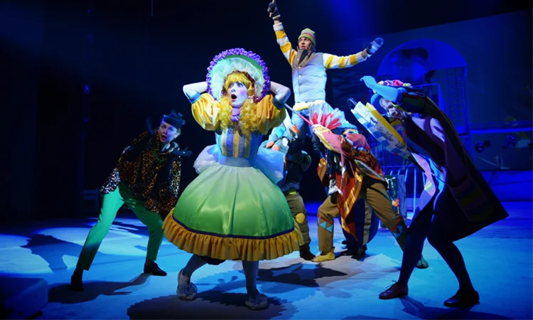 Ensemble Cast Performing Under Stage Lighting in Theater Production Theater performers in colorful costumes acting on stage under controlled lighting during live performance