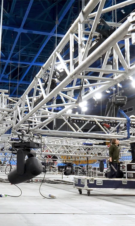 AV equipment racks with network switches, power distribution units, labeled hardware, and clean cable routing in entertainment venue