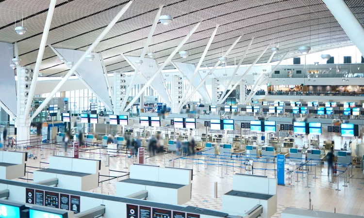Transportation Terminal Digital Display Systems and Passenger Flow Busy transportation terminal with multiple digital information displays and passengers moving through the concourse