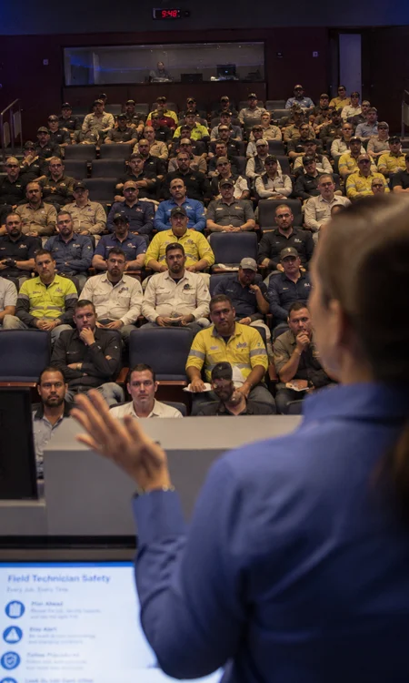 View from the stage during an FP&L field technician safety training session showing attendees in a modern auditorium