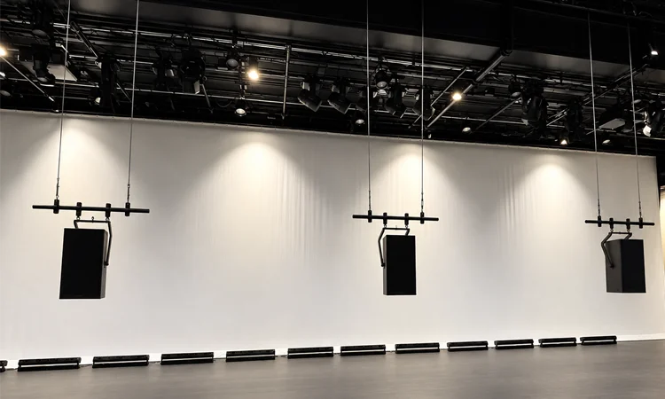 Glazer Hall Flown Loudspeaker System | Pro AVL Three flown loudspeakers installed beneath the theatrical lighting grid at Glazer Hall in Palm Beach, Florida.