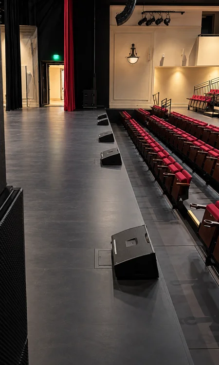 Glazer Hall Stage Front-Fill Audio System | Pro AVL Stage front-fill loudspeakers and tiered theater seating at Glazer Hall in Palm Beach, Florida.